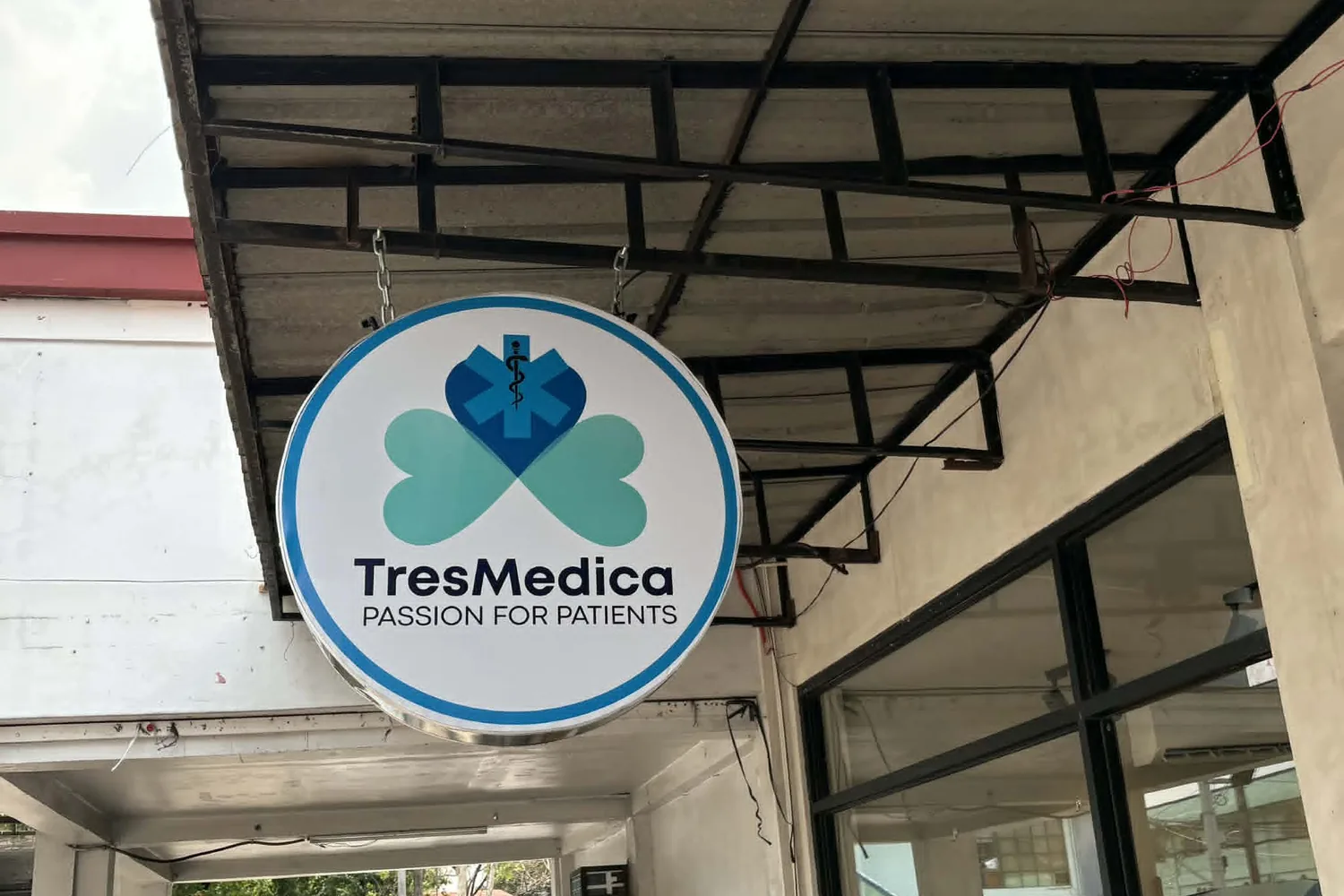 The round TresMedica Passion for Patients signage at the head office